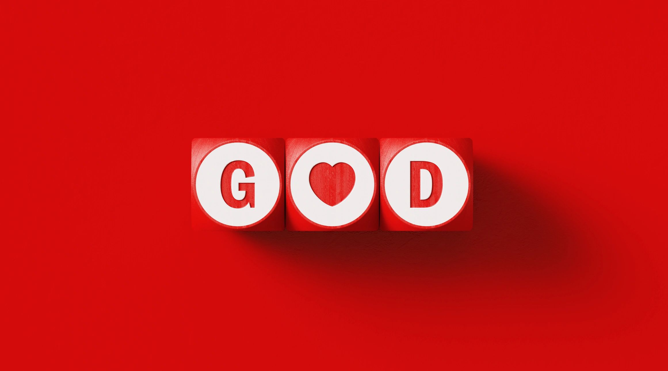 GOD written wood blocks sitting on red background.